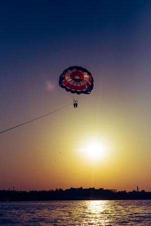 A vertical shot of a hot air balloon with the beautiful sunset sky in the backgroundの写真素材