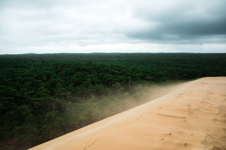A beautiful view of the Dune of Pilat in Bordeaux, France under a cloudy skyの写真素材