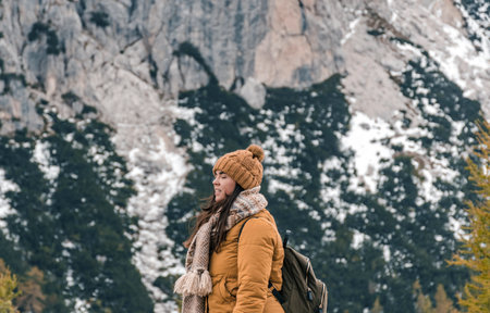 A close-up shot of a female hiker standing on a scenic viewpoint in mountains in Croatiaの写真素材