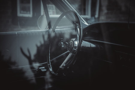 A closeup of the steering wheel of an old car.の写真素材