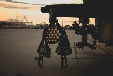 A closeup shot of a helicopter on the roof of a building on a blurred sunset background