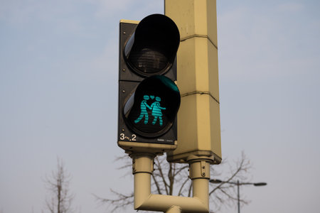 A closeup shot of a Dutch green traffic light showing two people in love
