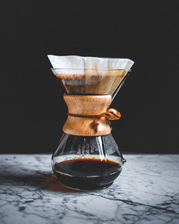 A vertical closeup shot of filtered coffee on a table