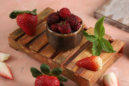 A wooden bowl filled with ripe raspberries