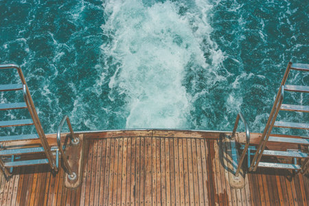 A wooden dock by the sea with splashing wavesの写真素材