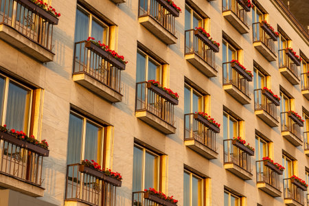 A low angle shot of a beautiful symmetric building with small balconies on it