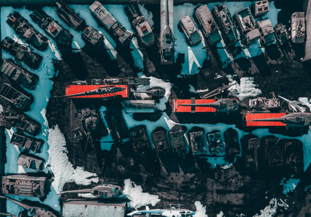 A top view shot of a bunch of parked cars with the ground covered in snowの写真素材