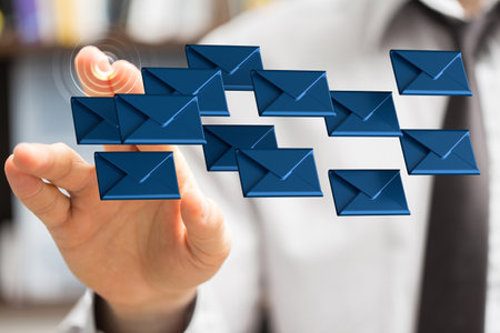 A male's hand pointing to an illustration of email inbox signsの写真素材