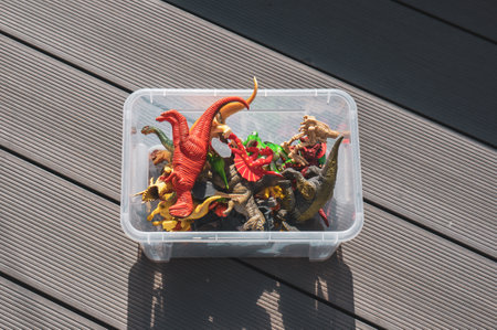 A closeup of a plastic container full of dinosaursの写真素材