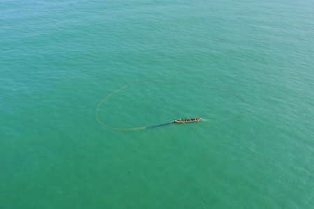 An aerial shot of a boat in a sea during the dayの写真素材