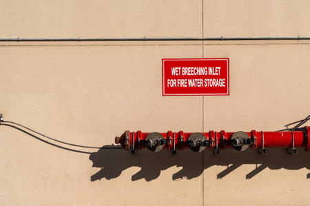 A closeup of valve metal water tap for water storage on the wall on a sunny day in Doha, Qatarの写真素材