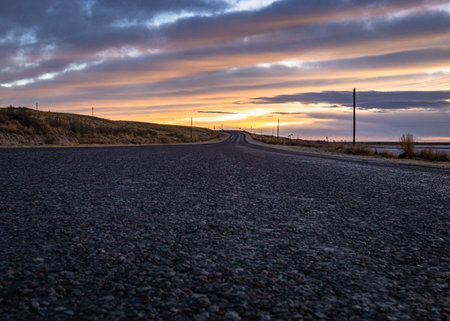 A beautiful shot of  road with sunset in the background