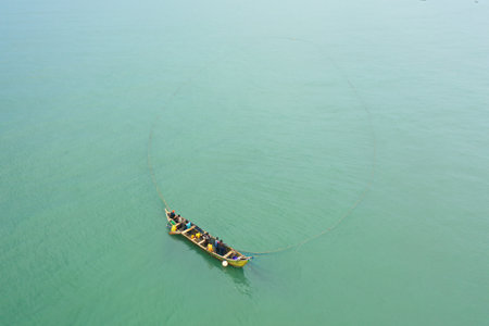 An aerial shot of a boat in a sea during the day