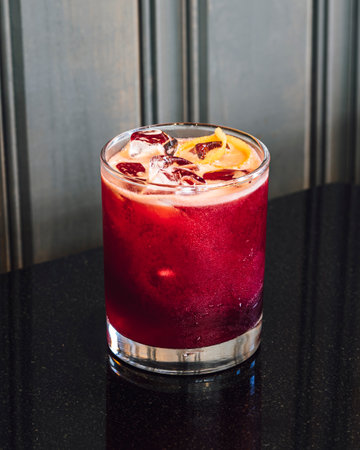 This deeply purple craft cocktail gets the intense color from infused rose hips. Garnished with a...