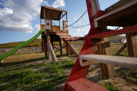 A view of a park with a playground under a cloudy sky
