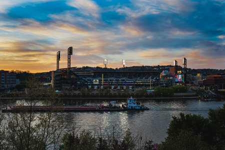 The riverside view of PNC Park baseball stadium against a cloudy sky in Pittsburgh, Pennsylvaniaの写真素材