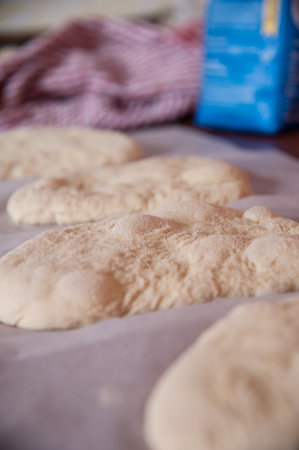 A selective focus shot of a dough bread on a light background