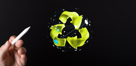A male pointing at the 3D rendering of the recycling logo with a pen