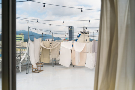 A roof with laundry hanging on the ropesの写真素材