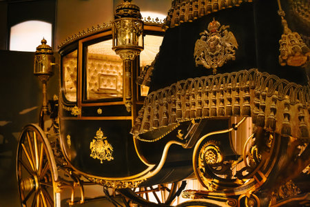 A closeup shot of a black carriage decorated with golden patter