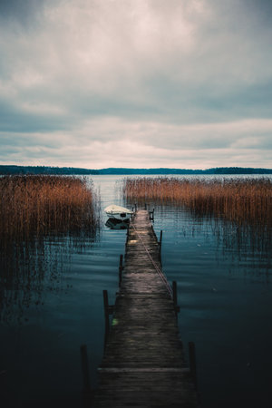 A vertical shot of an old pier by the Vittrask lake in Kirkkonummi, Finland on a gloomy dayの写真素材