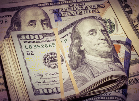 A stack of US states currency, 100 dollar banknotes