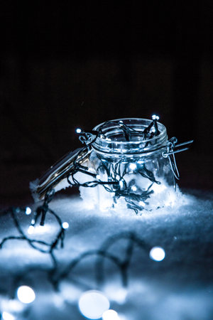A close-up shot of an empty jar covered with lights