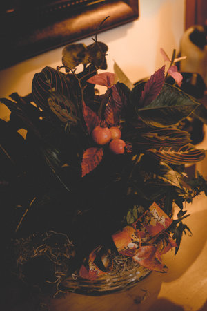 A vertical shot of a plant with colorful leaves in a glass vaseの写真素材