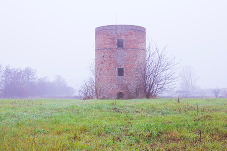 A beautiful shot of an old silo in the fog