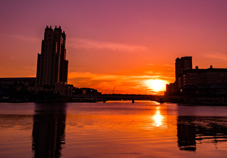 A beautiful shot of a sea with a red sunset sky in the backgroundの写真素材