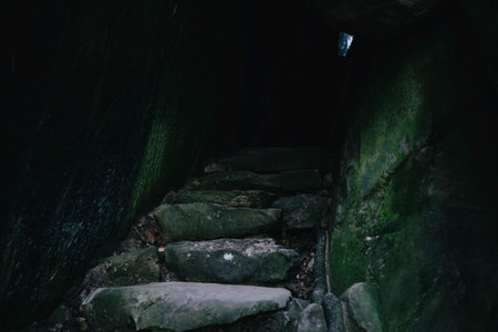 A closeup of the stone stair of a cave in darknessの写真素材