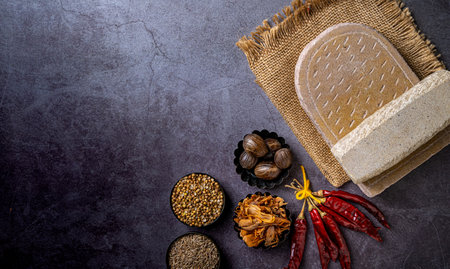 A top view of a stone board and Indian seasonings on a tableの写真素材