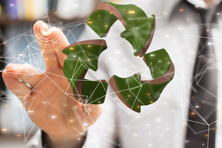 A businessman pointing at a digital render of a recycling sign-environment conceptの写真素材
