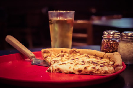 A beautiful shot of pizza slices and beer at pubの写真素材