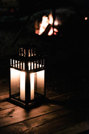 A verticle shot of a candle and bonfire in winter at Christmasの写真素材