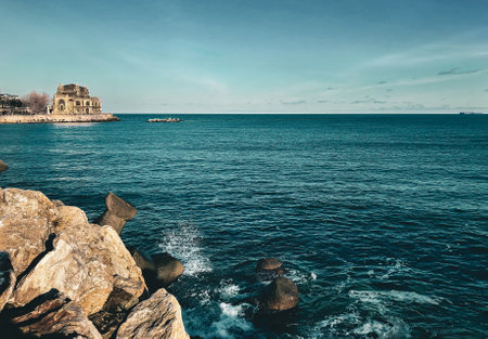 A beautiful view of an old building by the sea under a blue sky in Constanta, Romaniaの写真素材