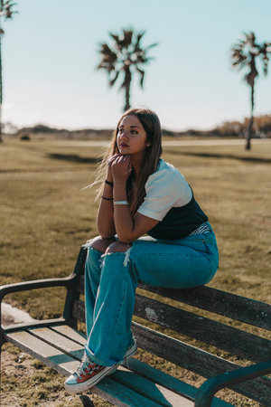 A pretty young brunette Spanish girl posing at the beachの写真素材
