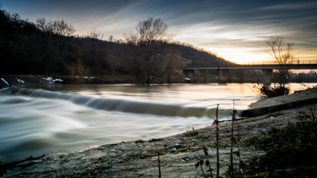 A view of a river at sunset with long exposure