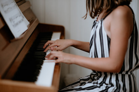A selective of female hands playing pianoの写真素材