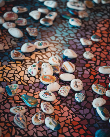 A closeup of handpainted peddles spread across the colorful tiles of a floor