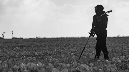 Young woman metal detecting in Denmarkの写真素材