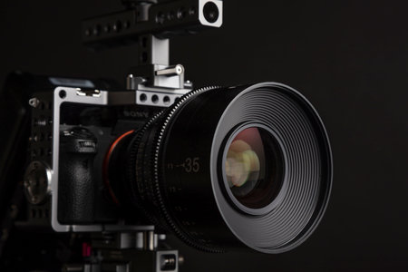 A closeup of a modern camera against the gray background