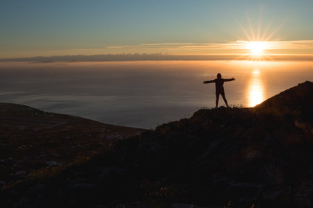 A silhouette of a guy on a beautiful sunrise background in Santoriniの写真素材