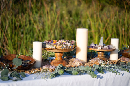 A beautifully decorated ceremonial table with mineral stones, smudging sticks, and candlesの写真素材