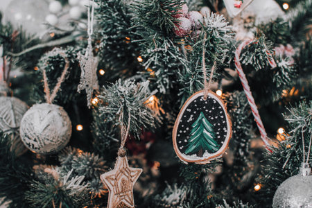 Close-up photo of a diy hand crafted christmas ornament with hand painted christmas tree on a wood slice. Home made christmas ornament.の写真素材