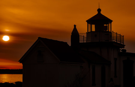 A beautiful shot of a lighthouse from the Discovery Park Beach in the Seattle areaの写真素材