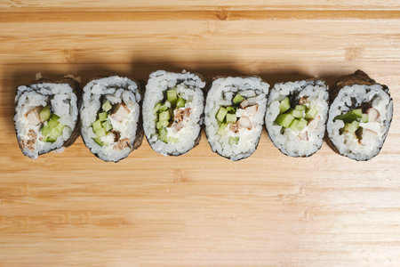 A top view of delicious rolled sushi on a wooden standの写真素材