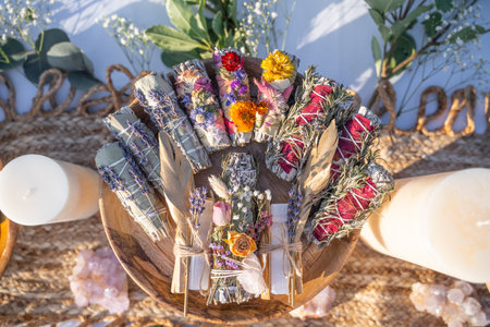 A top view of smudging sticks with dried flowers on a wooden trayの写真素材