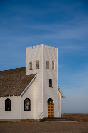 A view of a wooden church against a blue sky in the ghost town of Retlaw, Alberta, Canada.の写真素材