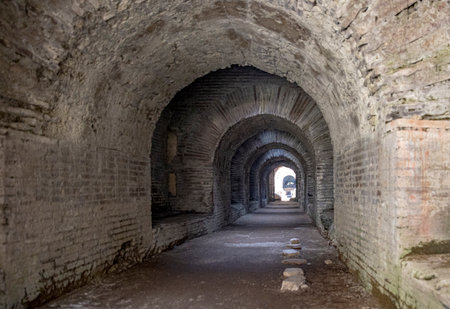 A historic stone tunnel through the Colosseum in Capua, Italyの写真素材